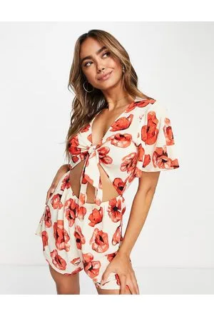 Monki Relaxed playsuit with tie front and frill sleeves in poppy print