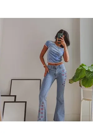 Labelrail X Pose and Repeat mid rise 90s flared jeans with butterfly appliques in