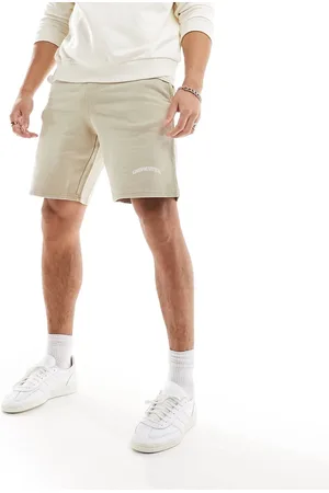 Good For Nothing Acid wash jersey shorts in beige with logo print