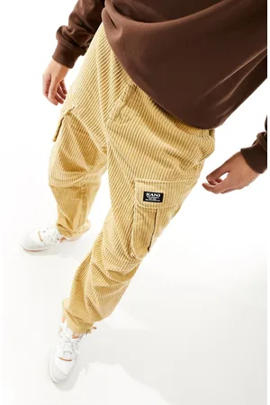 Karl Kani Straight leg cord cargo trousers in beige with logo print
