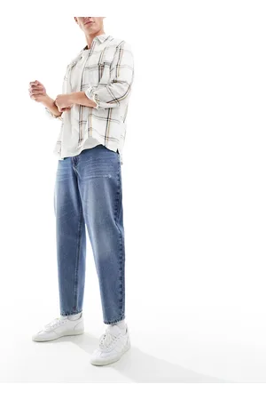 ASOS Tapered jeans with abrasions in mid wash