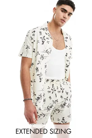 ASOS Co-ord seersucker swim shorts in beige with black floral print