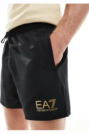 EA7 Armani gold logo swim shorts in